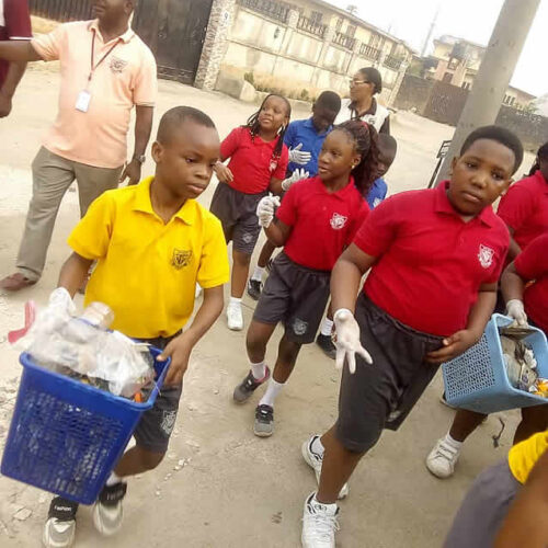 A section of Mayors school observing community cleaning